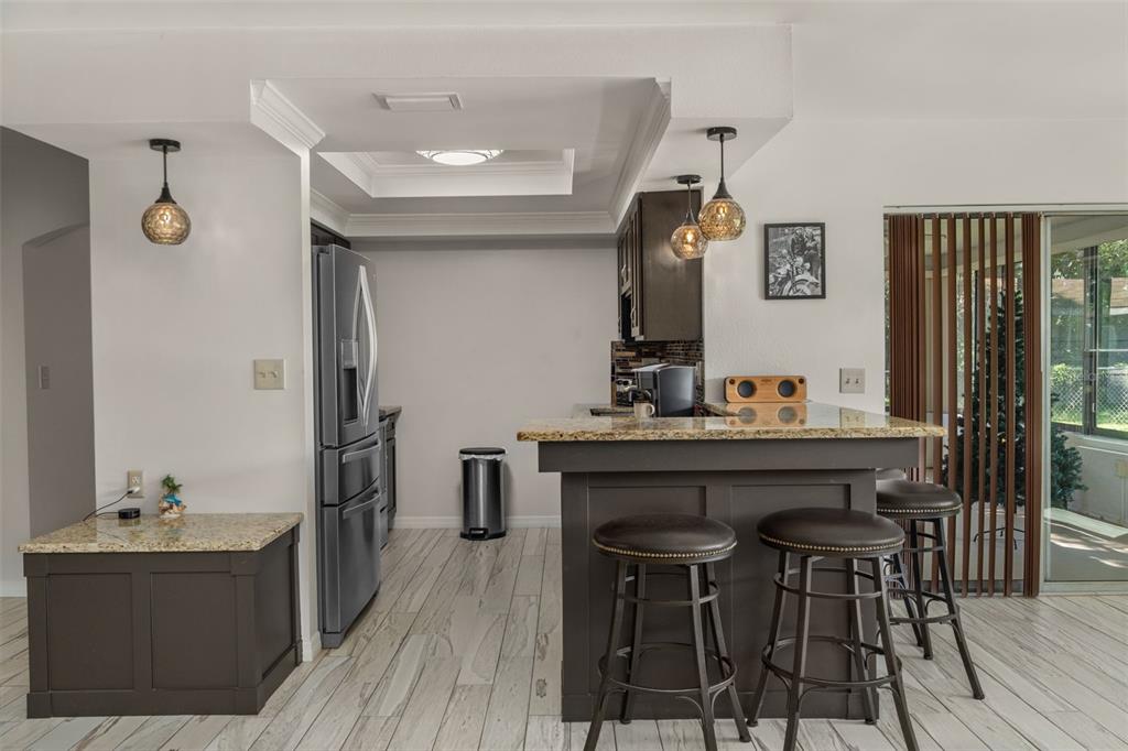 7606 Landmark Drive Spring Hill, FL 34606 - Photo 10 of 41 a view of a kitchen area with furniture and wooden floor