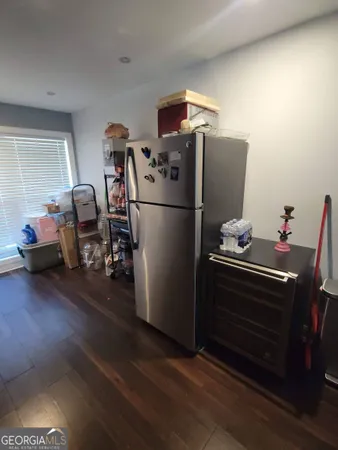 a kitchen with refrigerator and stove