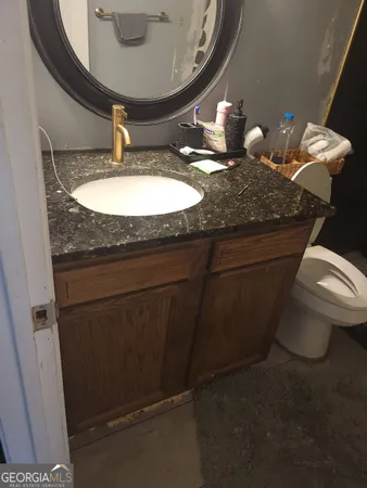 a bathroom with a toilet and a mirror