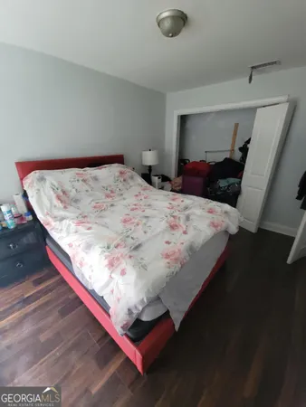 a bed sitting in a bedroom next to a window