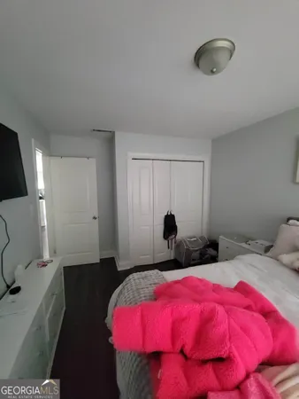 a bedroom with bed and window