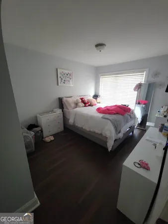 a bedroom with bed couch and window