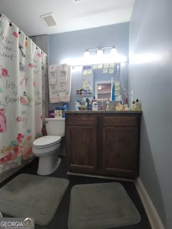 a bathroom with a bathtub and toilet