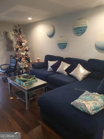 a living room with furniture and a chandelier