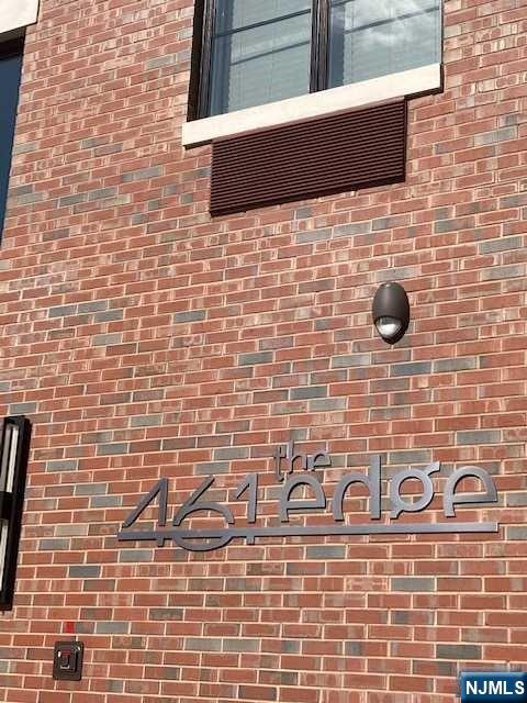 461 Palisades Boulevard, Unit 303 Fort Lee, NJ 07024 - Photo 1 of 13 a bathroom with a brick wall and a blue wall