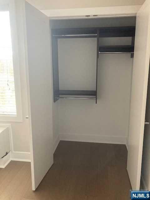 461 Palisades Boulevard, Unit 303 Fort Lee, NJ 07024 - Photo 11 of 13 an empty room with a bench