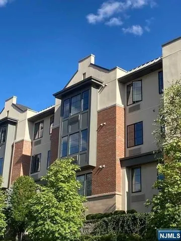 a view of a house with a yard and potted plants