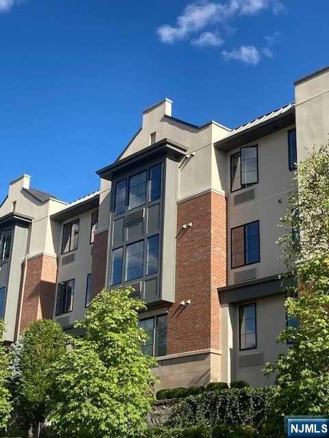 461 Palisades Boulevard, Unit 303 Fort Lee, NJ 07024 - Photo 2 of 13 a view of a house with a yard and potted plants