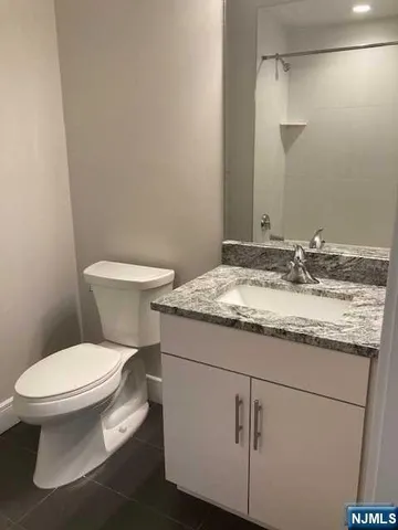 a white toilet sitting next to a bathroom sink