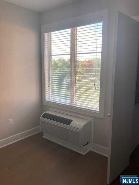 461 Palisades Boulevard, Unit 303 Fort Lee, NJ 07024 - Photo 10 of 13 a bath room with a window and a chair