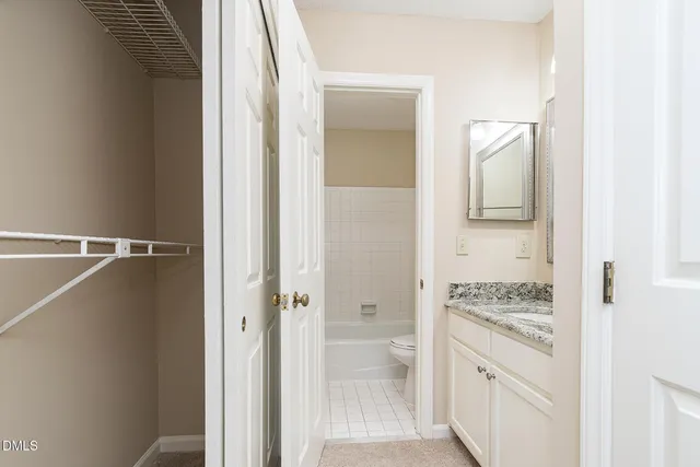 a bathroom with a granite countertop shower mirror and a sink