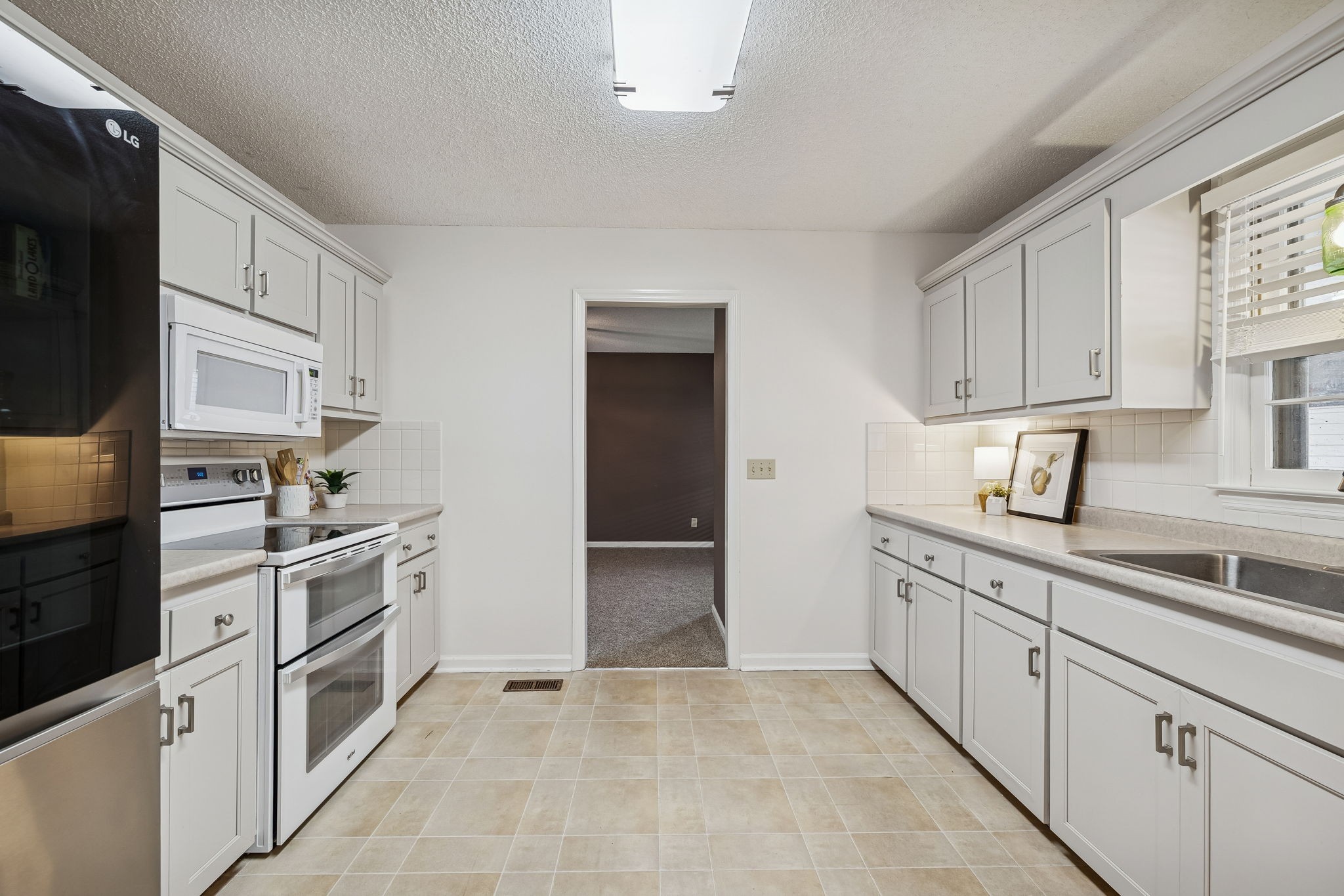 641 McKaig Road Murfreesboro, TN 37127 - Photo 11 of 51 a kitchen with granite countertop white cabinets and stainless steel appliances