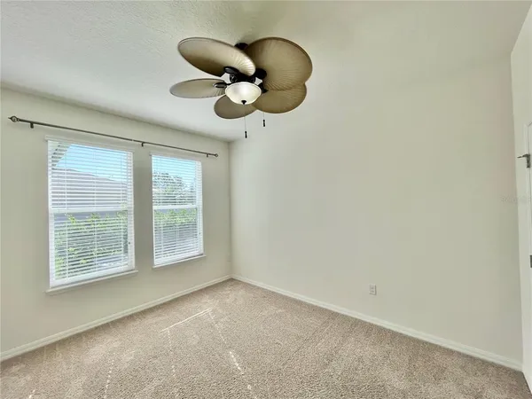 an empty room with a cabinet and a large window