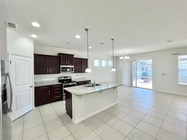 a large kitchen with cabinets and stainless steel appliances