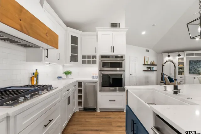 a kitchen with a sink stove and refrigerator