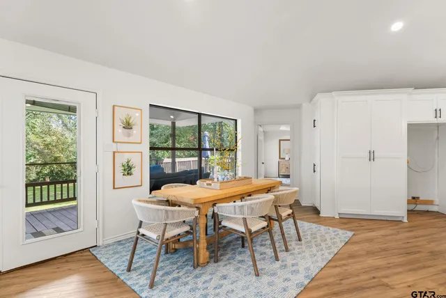 a dining room with furniture and wooden floor