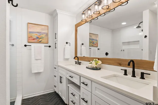 a bathroom with a double vanity sink and a mirror