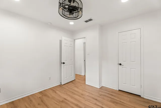 a view of an empty room and wooden floor