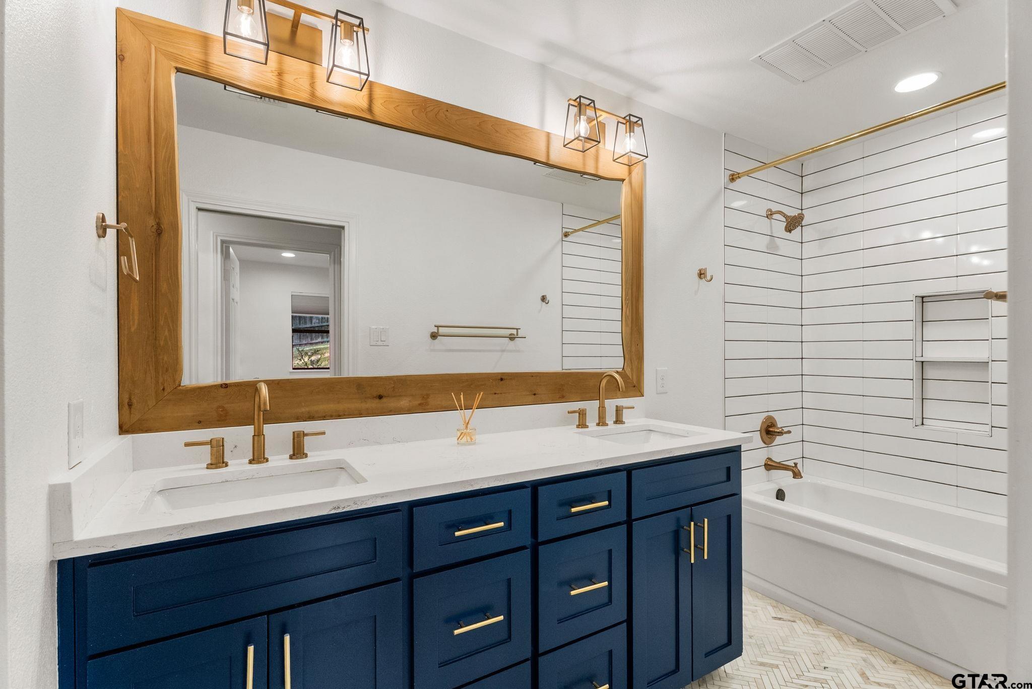 13235 Peninsula Road Whitehouse, TX 75791 - Photo 26 of 48 a bathroom with a sink double vanity granite tub and a mirror