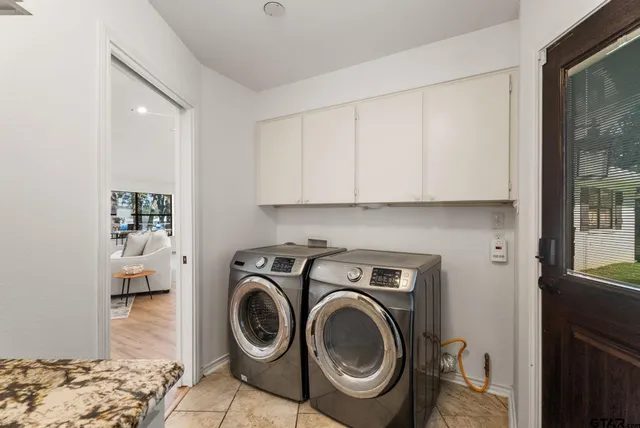 a utility room with sink dryer and washer