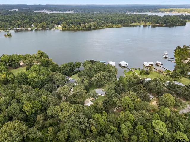 an aerial view of a houses with a lake view