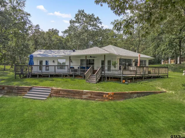 a front view of a house with a yard table and chairs