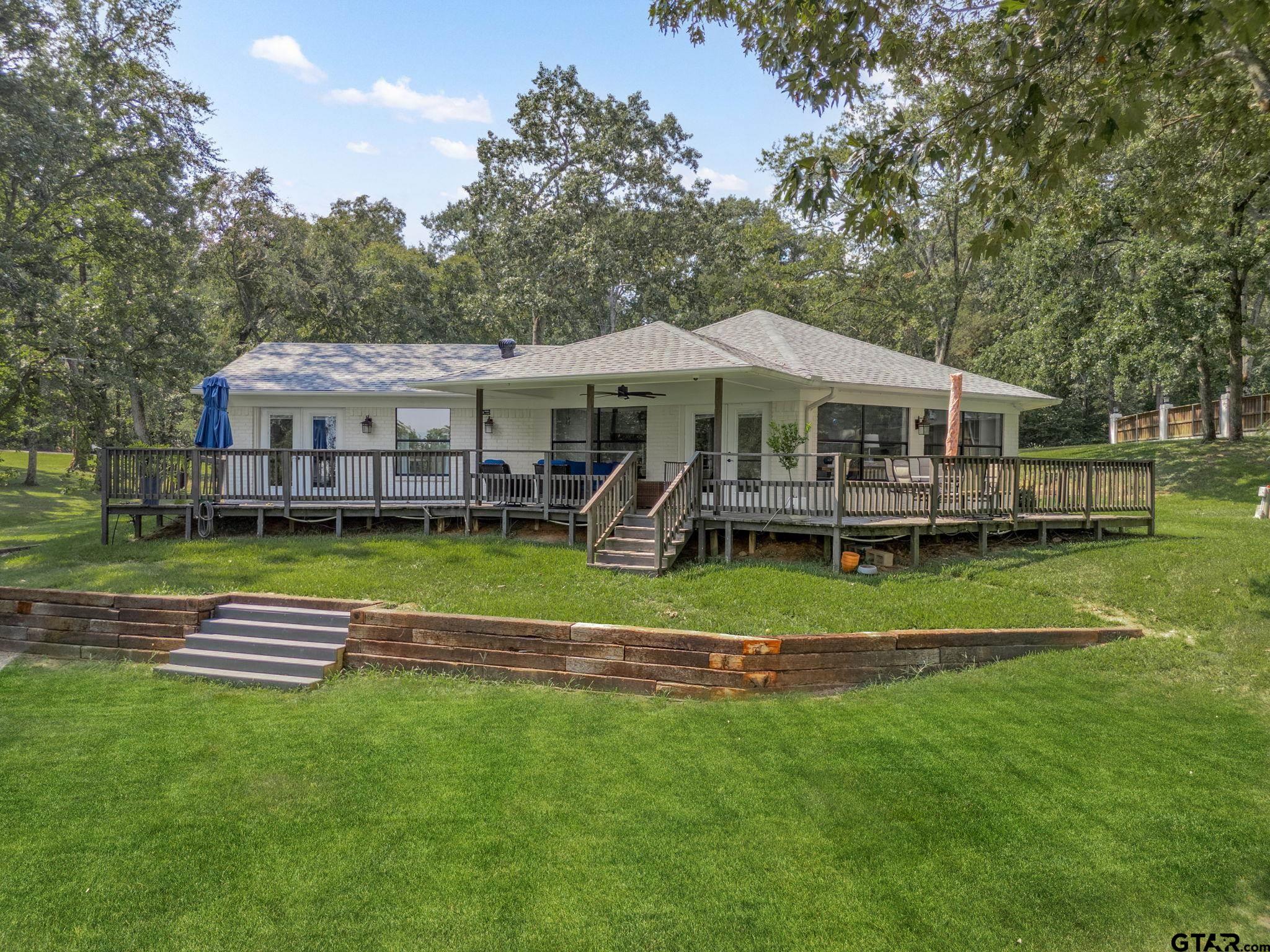 13235 Peninsula Road Whitehouse, TX 75791 - Photo 32 of 48 a front view of a house with a yard table and chairs