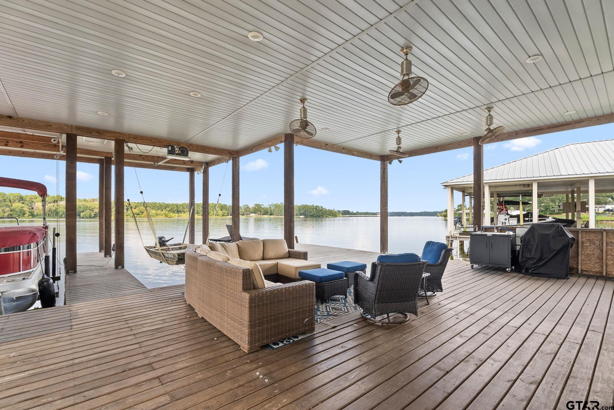 13235 Peninsula Road Whitehouse, TX 75791 - Photo 38 of 48 a living room with furniture large windows and wooden floor