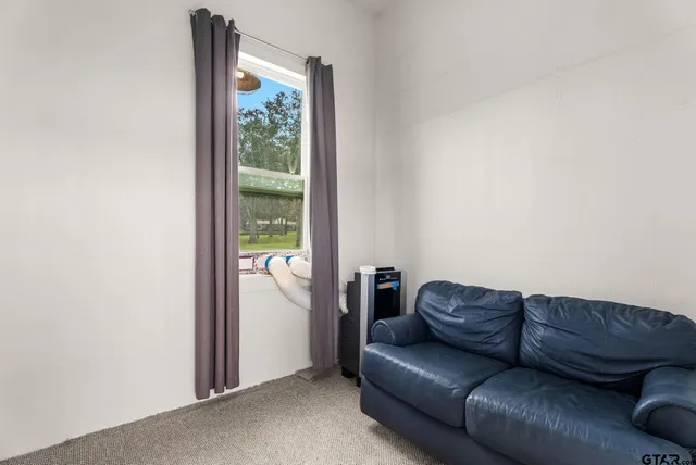 a living room with a couch and a window