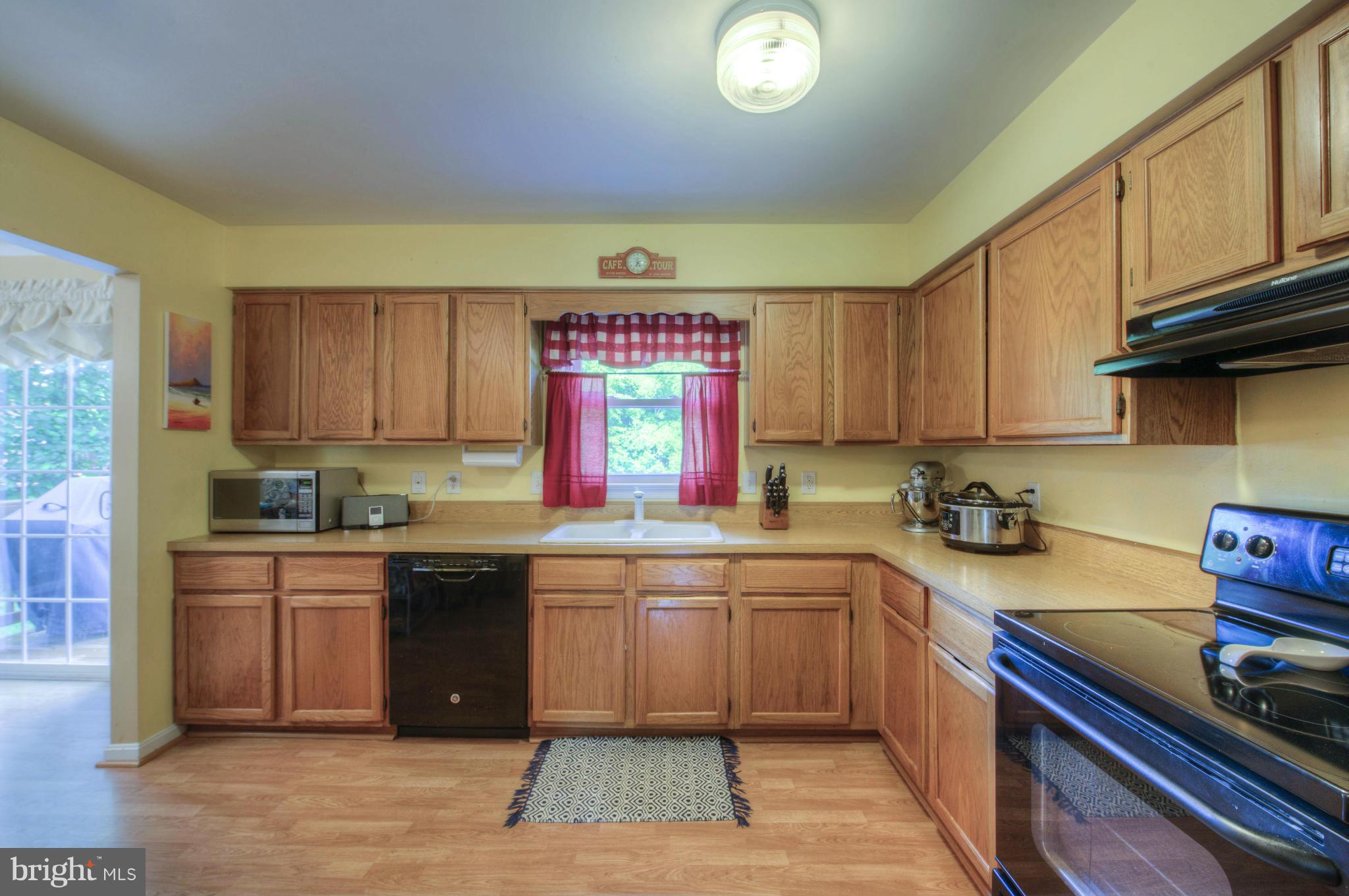 55 Buck Road Stafford, VA 22556 - Photo 6 of 19 a kitchen with a sink a stove and cabinets