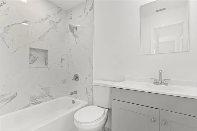 a bathroom with a sink a toilet and bathtub