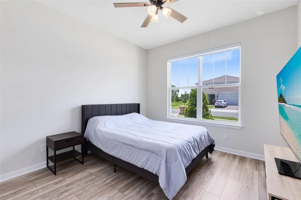 a bedroom with a bed and a window
