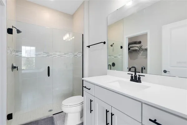 a bathroom with a sink toilet and shower