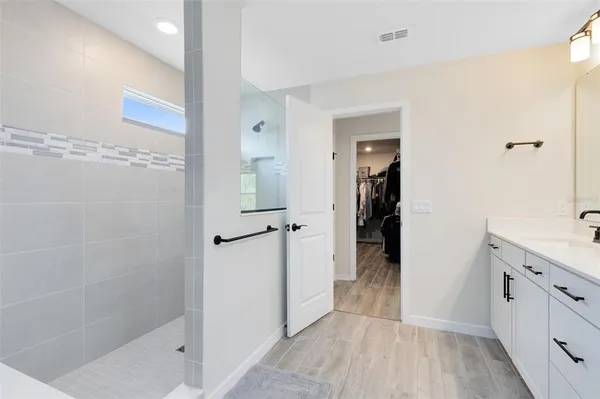 a bathroom with a shower and a sink