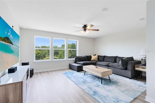 a living room with furniture and a large window