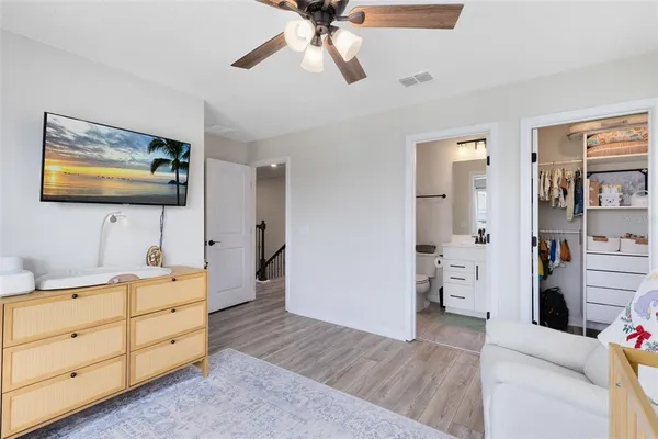 a view of room with cabinet and ceiling fan