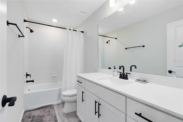 a bathroom with a sink toilet tub and shower