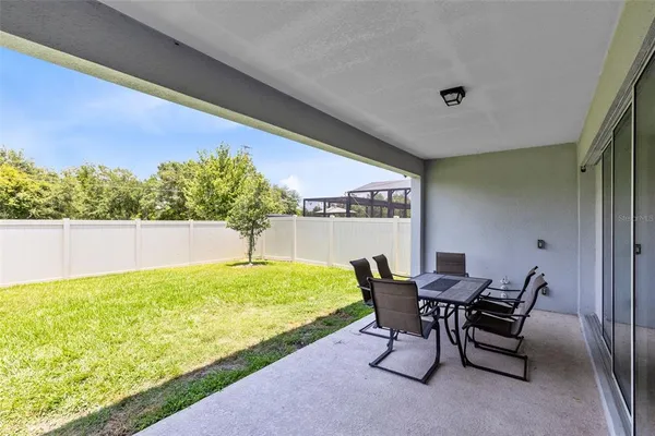 a view of a chairs and table in patio