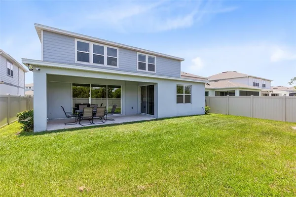 a view of a house with a yard and sitting area