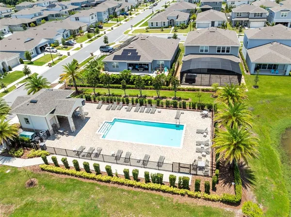 an aerial view of residential houses and car parked