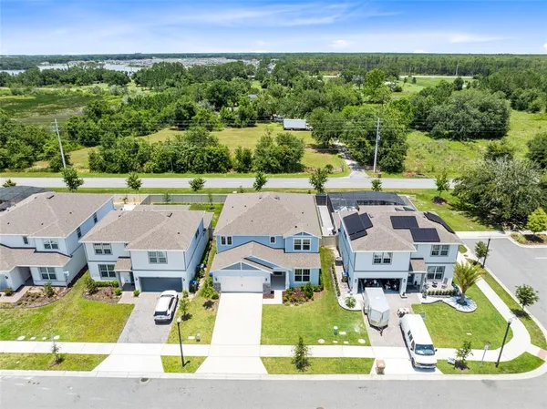 an aerial view of residential houses with outdoor space and street view