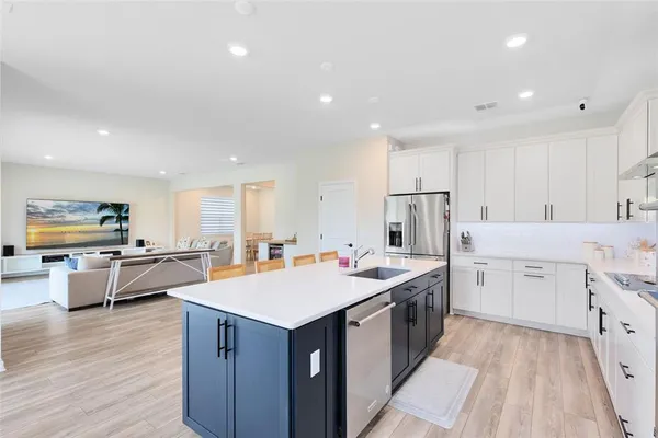 a kitchen with a sink stove and wooden cabinets