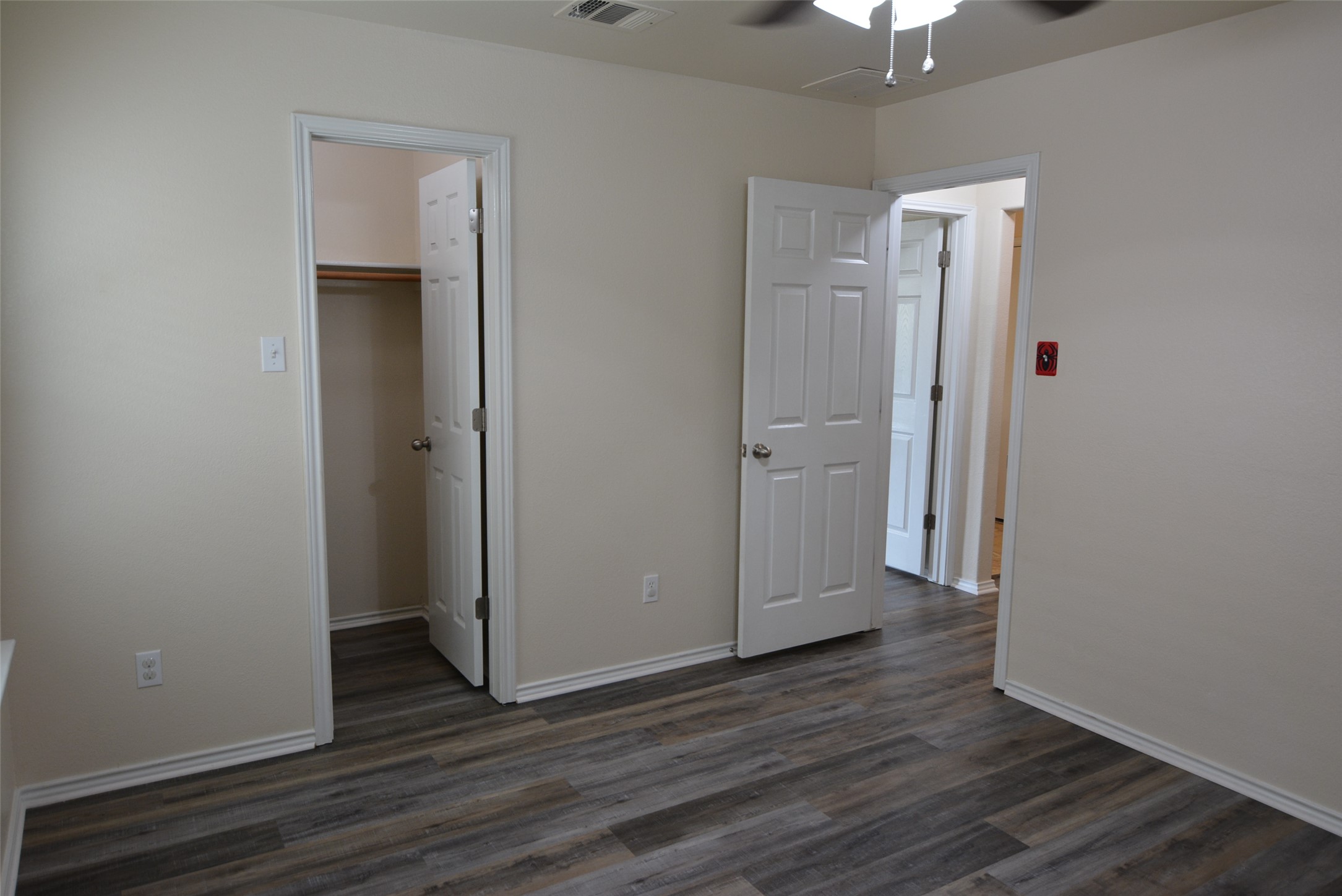 1303 Horseshoe Ranch Drive Leander, TX 78641 - Photo 21 of 26 Newly renovated room features rich wood-look flooring and crisp white trim throughout, offering versatile living space.