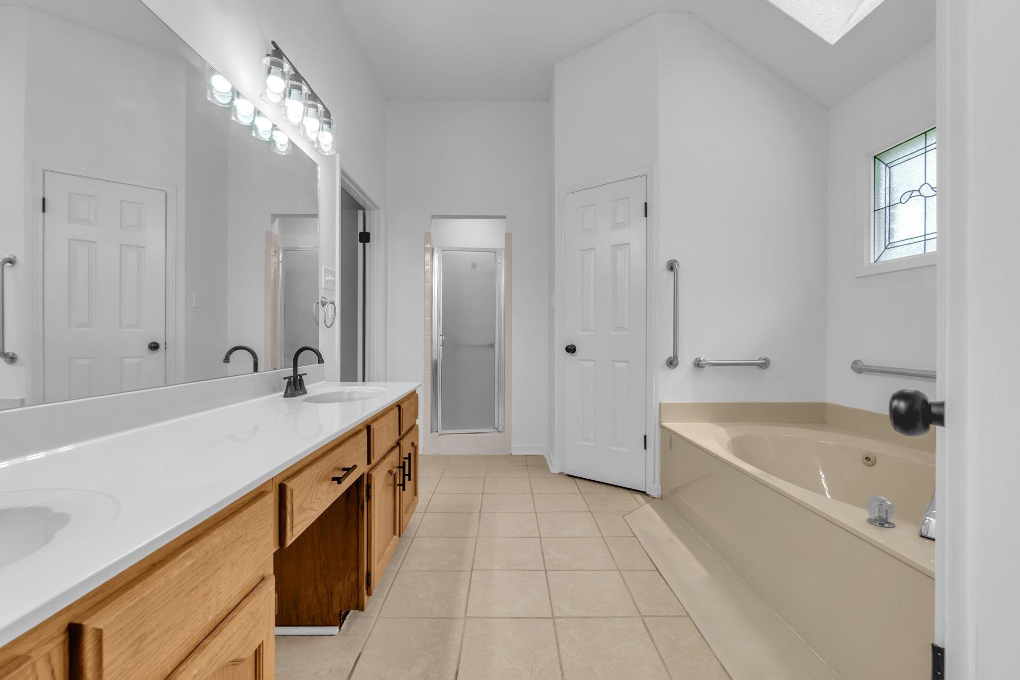 6613 Stephan Ridge Drive Bartlett, TN 38135 - Photo 21 of 24 Dual vanity with a continuous countertop, integrated sinks, and matte black fixtures