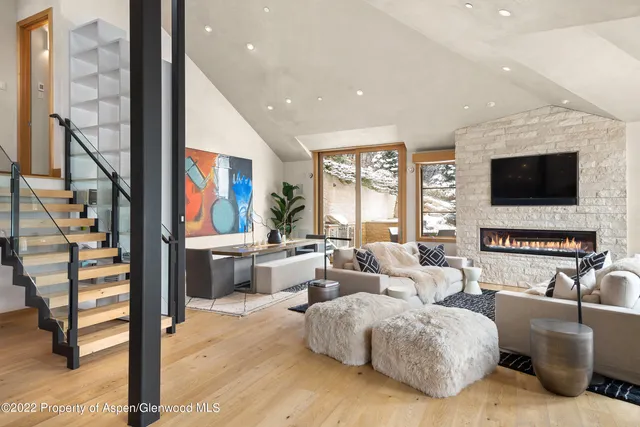a living room with fireplace furniture and a flat screen tv