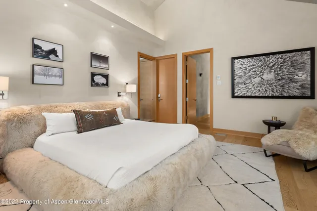 a bedroom with a large bed and a couch