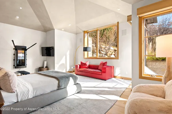 a bedroom with a large bed and a couch