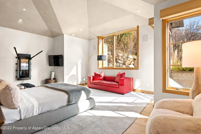 a bedroom with a large bed and a couch