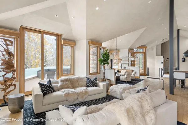 a bedroom with furniture and large windows