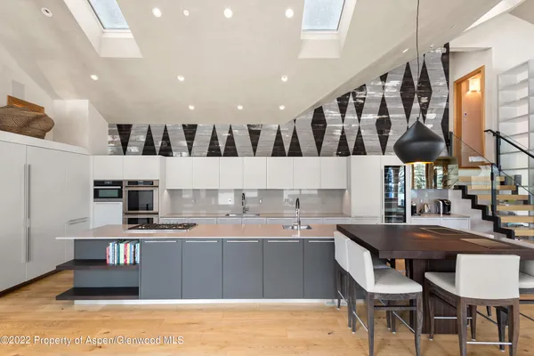 a kitchen with stainless steel appliances kitchen island granite countertop a sink and cabinets